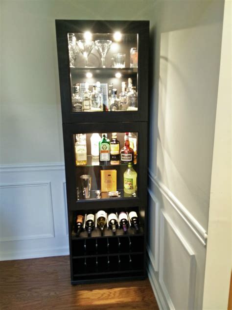 Custom configured IKEA cabinet with glass pane doors and built in lights -Great living room cabinet to hold anything from records, to games, to your bar . . Liquor cabinet ikea